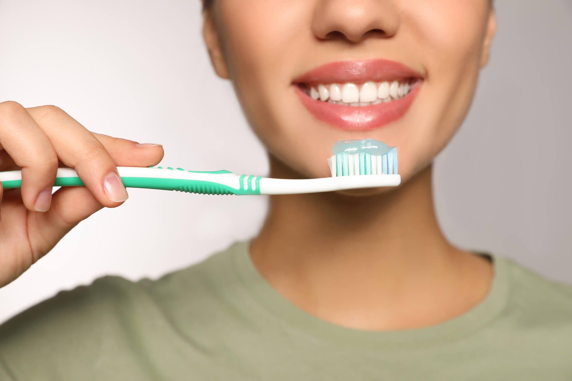 dentist in Lake Worth, FL and her toothbrush with toothpaste
