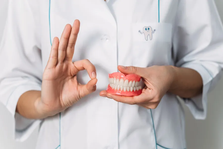 dentist holding denture