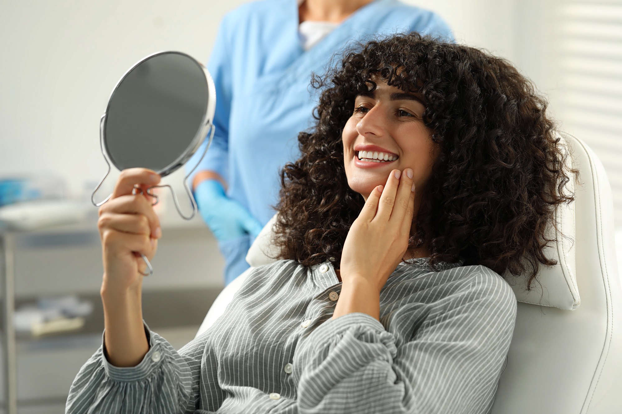 cosmetic dentist lake worth patient admiring smile results