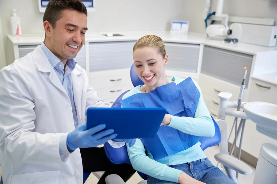 dentist reviewing treatment plan with patient at greenacres cosmetic dentistry