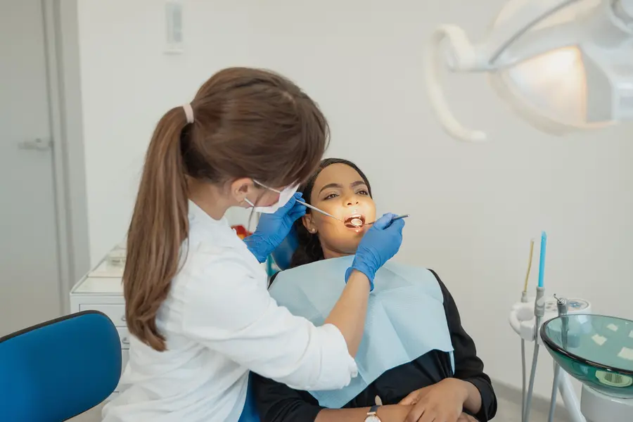 dentist-in-lake-worth-fl-examining-womans-teeth-during-checkup