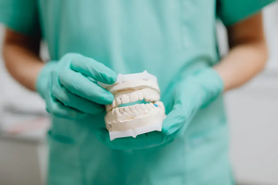 dentures-lake-worth-dentist-holding-plaster-teeth-mold-model